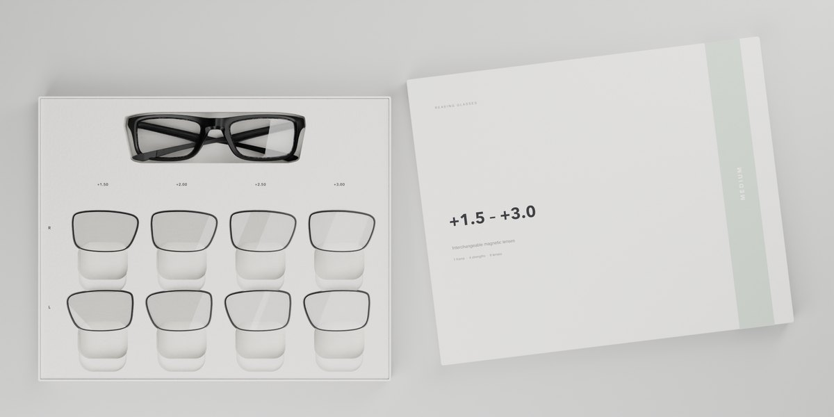 Open MEDIUM gift box seen from above: frame at the top, right-eye lenses in the upper row, left-eye lenses in the lower row, lid beside it